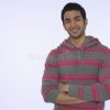 smiling-young-indian-man-portrait-against-purple-background-33897262